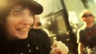 Mick Mars with a gun