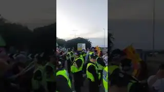 Police divide protesters outside Migrant hotel. Stuck in the middle filming