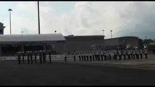 Military police precision drill squad performing with SAF band