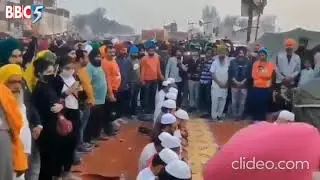 Sikh brothers standing in solidarity with Muslims while they offer Namaz during farmers protest -