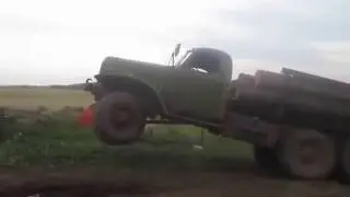 Overloaded log truck dancing