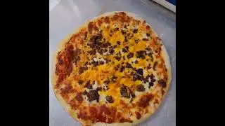 A beautiful beef pizza waiting to be cut.... #pizzeria #pizza #pizzalover #beef