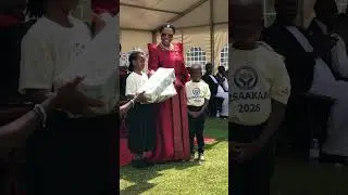 Children receive gifts from the Queen of Buganda.