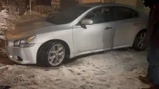 Car slips on ice, gets stuck in rut