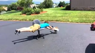 My brother having fun with a leaf blower and an office chair