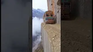 An Indian truck squeezes along a cliffside road and misses a deadly drop by mere centimeters.