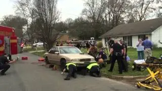Police, fire rescue man trapped under car