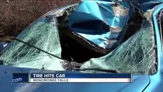 Tire flies from semi and hits car