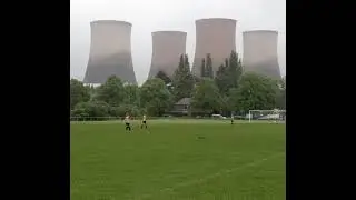 Four giant cooling towers of a power station are getting toppled