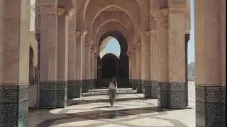 Free Footages | Architecture | Woman Walking on Facade of Concrete Pillars Arches