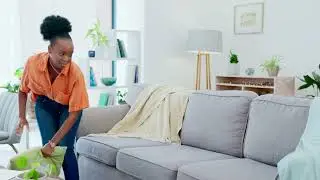 black woman cleaning and laundry basket with clot