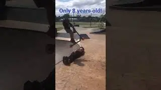 8 year old jumps over person #trending #shorts #skills #skatepark #scooter #shredding