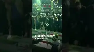 Iranians gather to mourn security forces killed during protests