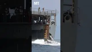 See amphibious combat vehicles plunge into the water during launch and recovery drills
