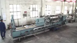 Flaking mill roll grinder to rough