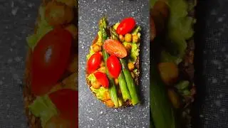 Smashed avocado on toast, topped with spicy chickpeas, plum tomatoes and saut&eacute;ed asparagus. Enjoy!