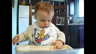 Eating a banana. tossing on floor, open and close the tray, smashed his fingers closing at end