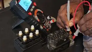 Testing the Rolls Royce Ghost air pump solenoid value with a meter.