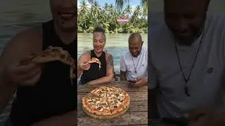 Eating extra large pizza in Jamaica, river yard style settings
