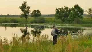 Man Walking Along Lake Slowly Summer Landscape Forest Swamp High Green Grass Field Smooth Water in