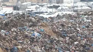 Palestinians exposed to harsh winter weather search through rubbish to find items to keep warm
