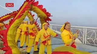 People perform dragon and lion dances to welcome the Spring Festival
