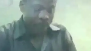 A postal worker in Ghana making music as he cancels stamps.