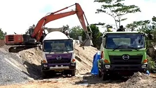 Excavator Prepares Coral Stone and Cement for Powerful Concrete Mixer Action