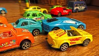 Plastic Toy Cars of Various Colours Going Out of the Box