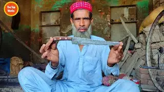 Old blacksmith making a traditional Knife out of an old Motorcycle Wheel Axle - The top works