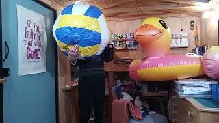 Ballooner Tick blows up a gigantic beach ball 
