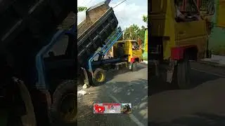 Dump truck jomplang muatan batu gunug