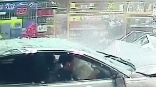 Car plows into store, woman miraculously walks away