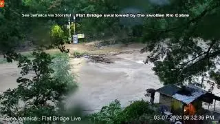 Historic Jamaican landmark, the Flat Bridge swallowed by the swollen Rio Cobre