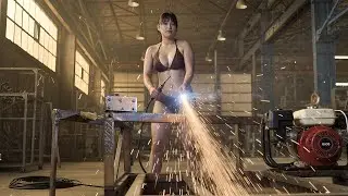 The female mechanic repaired and maintained the generator and restored the tractor engine.