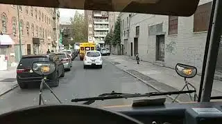 Dashcam: NYPD cop car passes school bus on sidewalk