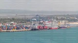 Aerial view of various containers stored in the container terminal near water timelapse, Setubal
