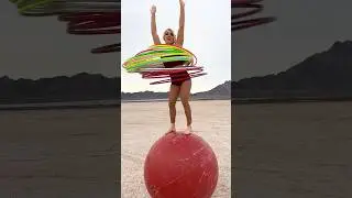 Most hula hoops spun simultaneously while balancing on a giant rolling globe - 28 by Grace Good 🇺🇸