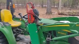 Homemade chainsaw holder on John Deere 300E loader