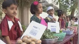 Dressed as vegetable vendors, kids urge people to go digital