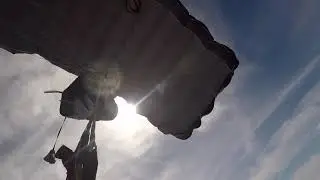 Soccer Players Scatter as Skydiver Lands on Field During Game in Northern Poland