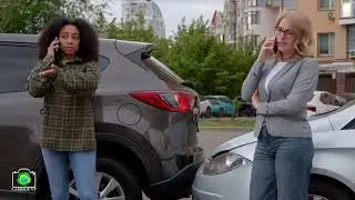 Multiracial female drivers of smashed vehicle calling for roadside assistance