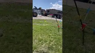 Peterbilt 379 unloading wood with a John Deere wheel loader with forks