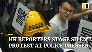 Hong Kong reporters stage silent protest at police presser