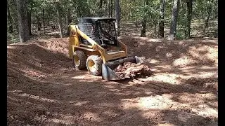 Digging a small pond in a forest w/ a skid steer