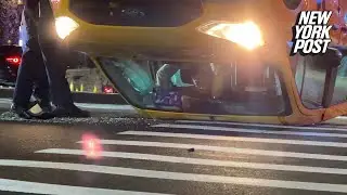 NYC taxi driver trapped upside down after cab flips