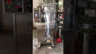 Automatic corn ear bagging machine with liquid doser and vacuum refiller
