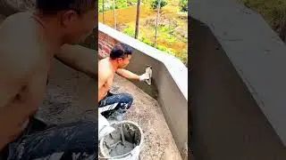 Applying a smooth cement coating to cover and protect the exposed red brick wall surface