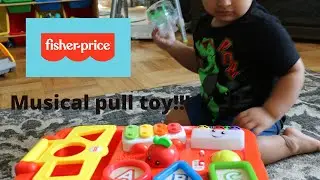 Saleh plays with Fisher price laugh and learn wagon pull toy