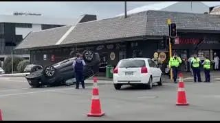Intersection crash results in a car flipping over